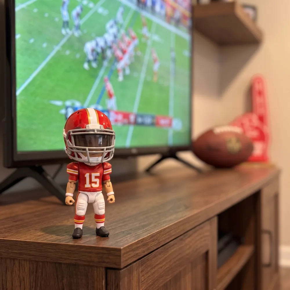 Mini football figure on a fan cave shelf